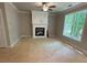 This cozy living room showcases a fireplace, crown molding, and a large window at 3089 Corbin Ave, Decatur, GA 30034