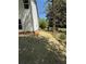 Side yard featuring fresh landscaping, newly laid pine straw, and mature shade trees at 3089 Corbin Ave, Decatur, GA 30034