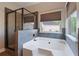 Bathroom with a soaking tub, glass shower, and natural light at 4360 Carver Ct, Cumming, GA 30040