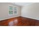 An empty room with hardwood floors and windows that allow natural light to enter at 4360 Carver Ct, Cumming, GA 30040