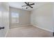 Neutral bedroom with a ceiling fan, carpet, and a window letting in natural light at 4360 Carver Ct, Cumming, GA 30040