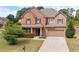 Charming two-story brick home with a well-manicured lawn and attached two-car garage at 4360 Carver Ct, Cumming, GA 30040