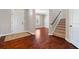 Welcoming foyer with hardwood floors, staircase, and a view into a naturally lit room at 4360 Carver Ct, Cumming, GA 30040