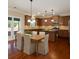 Eat-in kitchen features stainless appliances, center island, and seamless connection to the outdoor patio area at 4360 Carver Ct, Cumming, GA 30040