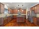 Spacious kitchen with wood floors, granite counters, stainless appliances, and central island at 4360 Carver Ct, Cumming, GA 30040