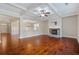 Bright living room featuring hardwood floors, a stone fireplace, and an open layout for entertaining at 4360 Carver Ct, Cumming, GA 30040