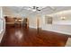 Open-concept living area featuring hardwood floors, high ceilings, and a partial view to the kitchen at 4360 Carver Ct, Cumming, GA 30040