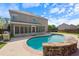Sparkling pool with stone details, alongside a screened-in porch and spacious patio perfect for relaxing at 4360 Carver Ct, Cumming, GA 30040