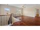 Upstairs landing with decorative wrought iron, hardwood floors, and natural light at 4360 Carver Ct, Cumming, GA 30040
