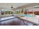 Relaxing sunroom leading to a backyard pool surrounded by beautiful landscaping at 4360 Carver Ct, Cumming, GA 30040