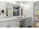 Bright bathroom featuring double vanities, a large mirror, and an adjacent shower at 479 Clifton Se St, Atlanta, GA 30316