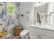 Charming powder room with floral wallpaper and a modern vanity at 479 Clifton Se St, Atlanta, GA 30316