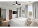 Bright bedroom features hardwood floors, a ceiling fan, and lots of natural light through large windows at 479 Clifton Se St, Atlanta, GA 30316