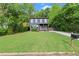 Charming two-story home with a well-manicured lawn, mature trees, and driveway at 479 Clifton Se St, Atlanta, GA 30316