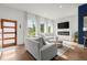 Bright living room featuring modern sofas, large windows, and an eye-catching fireplace at 479 Clifton Se St, Atlanta, GA 30316