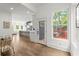 Open-concept living room leading into the kitchen with an island bar and outdoor deck access at 479 Clifton Se St, Atlanta, GA 30316
