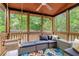 Inviting screened porch with a comfortable seating area, swing, and a view of the lush backyard at 479 Clifton Se St, Atlanta, GA 30316