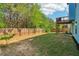 Large backyard with lush green grass and a wood fence provides privacy for outdoor activities at 4970 Roseman Trl, Cumming, GA 30040