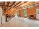 Unfinished basement with exposed ceiling beams and wood framing offers potential for customization at 4970 Roseman Trl, Cumming, GA 30040