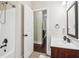 Bathroom featuring a shower/tub, single sink vanity, and a dark framed mirror at 4970 Roseman Trl, Cumming, GA 30040
