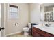 Bathroom featuring a toilet, window, and single sink vanity with modern fixtures at 4970 Roseman Trl, Cumming, GA 30040