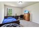 Inviting bedroom featuring carpet, a large window, a bed, and a dresser with a TV at 4970 Roseman Trl, Cumming, GA 30040