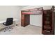 Carpeted bedroom with a desk and a unique bunk bed with storage drawers and a ladder at 4970 Roseman Trl, Cumming, GA 30040