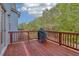 Wooden deck with stained railings provides a great outdoor space for relaxation and entertaining at 4970 Roseman Trl, Cumming, GA 30040
