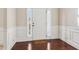 Welcoming foyer with dark hardwood floors, white trim, and a sidelight window at 4970 Roseman Trl, Cumming, GA 30040