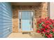 Close up of the front door with stone accents and red flowers at 4970 Roseman Trl, Cumming, GA 30040