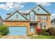 Charming two-story home with a blue garage door and brick accents at 4970 Roseman Trl, Cumming, GA 30040