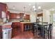 Eat-in kitchen with granite countertops, dark wood cabinets, and stainless steel appliances at 4970 Roseman Trl, Cumming, GA 30040