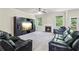 Cozy living room with a fireplace, a ceiling fan, and an entertainment center at 4970 Roseman Trl, Cumming, GA 30040