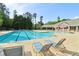 Community swimming pool featuring lounge chairs and a pool house, creating a resort-style oasis at 4970 Roseman Trl, Cumming, GA 30040