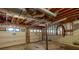 Unfinished basement with exposed ductwork and garage door at 6841 Fairway Ridge Dr, Douglasville, GA 30134