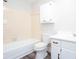 Full bathroom with a shower-tub combo, white fixtures, and tiled walls at 6841 Fairway Ridge Dr, Douglasville, GA 30134
