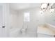 White bathroom featuring tiled floor, a bath tub, window and a vanity at 6841 Fairway Ridge Dr, Douglasville, GA 30134
