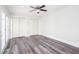 Spacious bedroom featuring a ceiling fan, hardwood floors, and access to the exterior of the home at 6841 Fairway Ridge Dr, Douglasville, GA 30134