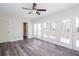 Bedroom featuring a ceiling fan, wood-look floors, and exterior doors leading to a deck at 6841 Fairway Ridge Dr, Douglasville, GA 30134