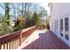 Exterior wooden deck with a brown wooden railing and backyard views at 6841 Fairway Ridge Dr, Douglasville, GA 30134