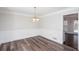 Bright dining room features decorative wainscoting, wood-look flooring, and an elegant chandelier at 6841 Fairway Ridge Dr, Douglasville, GA 30134