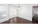 Dining room with dark wood floors, a chandelier, and double doors leading to the backyard at 6841 Fairway Ridge Dr, Douglasville, GA 30134