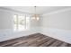 Bright dining room features decorative wainscoting, wood-look flooring, and a bay window at 6841 Fairway Ridge Dr, Douglasville, GA 30134