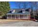 Inviting brick home with a white porch railing, offering a classic and welcoming curb appeal at 6841 Fairway Ridge Dr, Douglasville, GA 30134