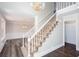 Elegant foyer with a grand staircase, beautiful chandelier, and newly installed hardwood floors at 6841 Fairway Ridge Dr, Douglasville, GA 30134