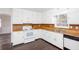 Charming kitchen with white cabinets, wood countertops, black appliances, and a window view at 6841 Fairway Ridge Dr, Douglasville, GA 30134