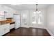 Bright kitchen features white cabinets, wood countertops, a white refrigerator, and exterior doors at 6841 Fairway Ridge Dr, Douglasville, GA 30134