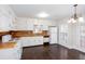 Charming kitchen with white cabinets, wood countertops, a white refrigerator, and dark wood flooring at 6841 Fairway Ridge Dr, Douglasville, GA 30134