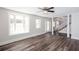Bright and spacious living room with columns, large windows, and stylish hardwood flooring at 6841 Fairway Ridge Dr, Douglasville, GA 30134