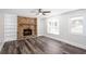 Inviting living room with a stunning stone fireplace, built-in shelving, and large bay window at 6841 Fairway Ridge Dr, Douglasville, GA 30134